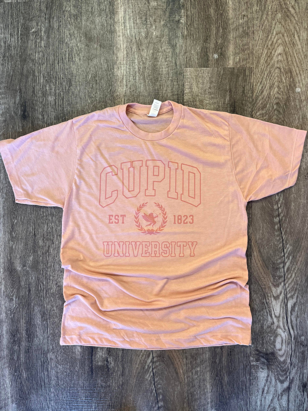 Cupid University Pink Print On Heather Peach - Adult & Kids T-Shirts, Sweatshirts & Hoodies apparel design preview 1