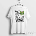 Classic Grinch Bow Dont Worry About Getting Older You - Adult & Kids T-Shirts, Sweatshirts & Hoodies apparel design preview 1