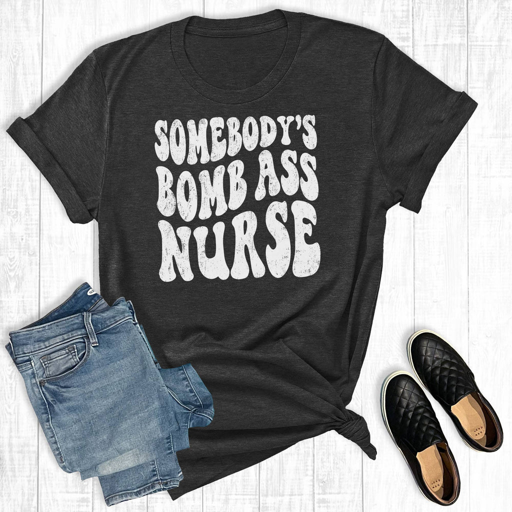 Somebody's Bomb Ass Nurse Graphic - Adult & Kids T-Shirts, Sweatshirts & Hoodies apparel design preview 1