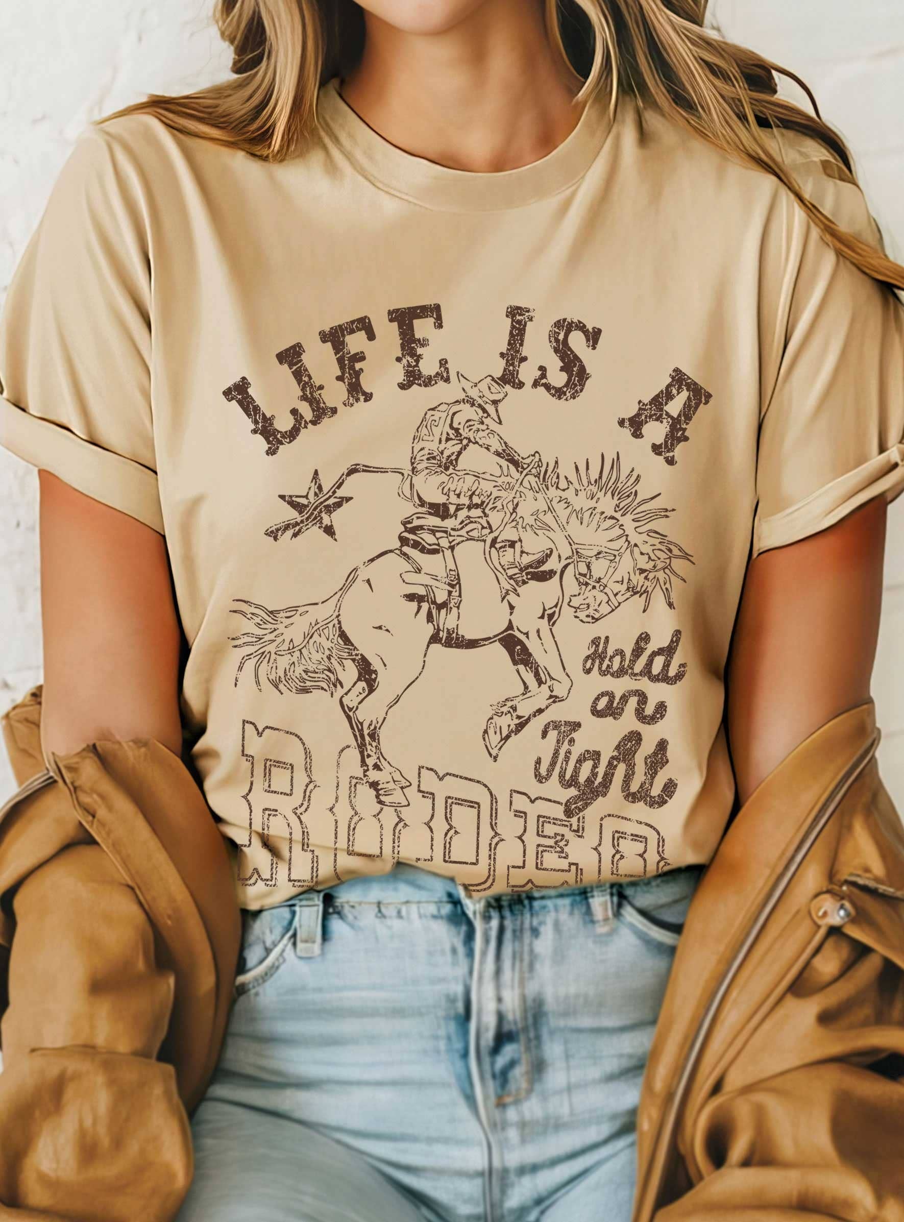 Life Is A Rodeo Cowboy Hold On Tight Graphic - Adult & Kids T-Shirts, Sweatshirts & Hoodies apparel design preview 1